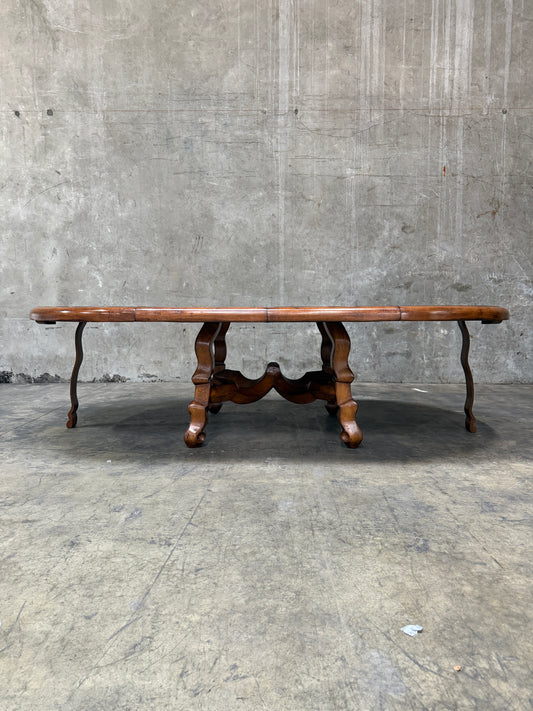 Custom Early Spanish Style Walnut Dining Table – Round to Oval with Leaves, Carved Stretcher Base, 107″L × 60″W × 30″H