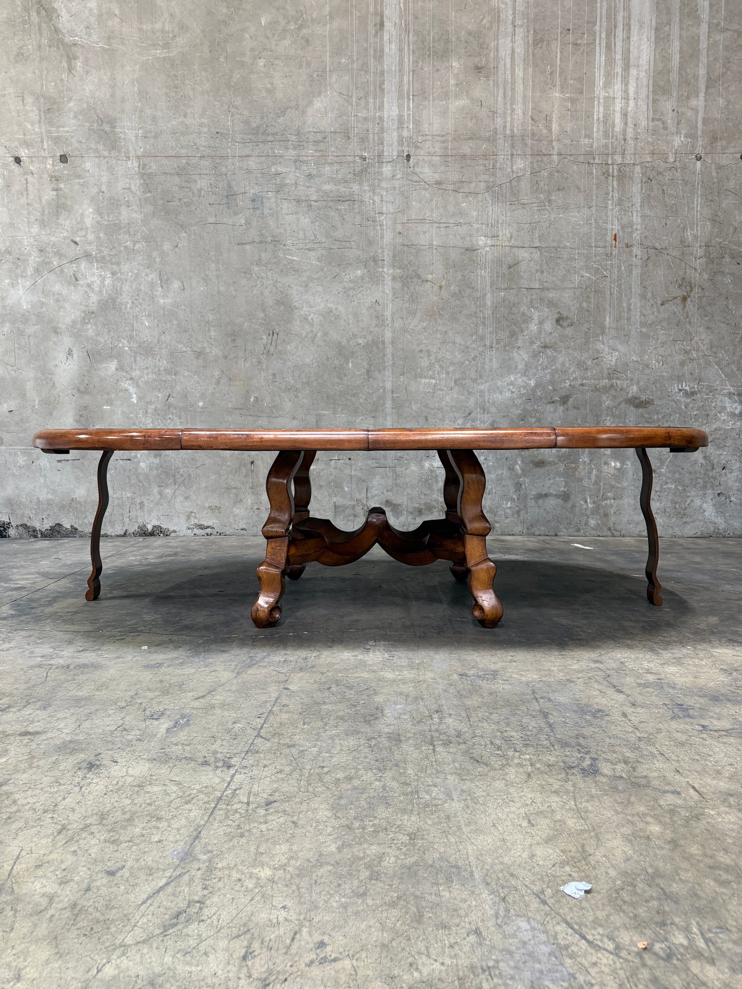 Custom Early Spanish Style Walnut Dining Table – Round to Oval with Leaves, Carved Stretcher Base, 107″L × 60″W × 30″H