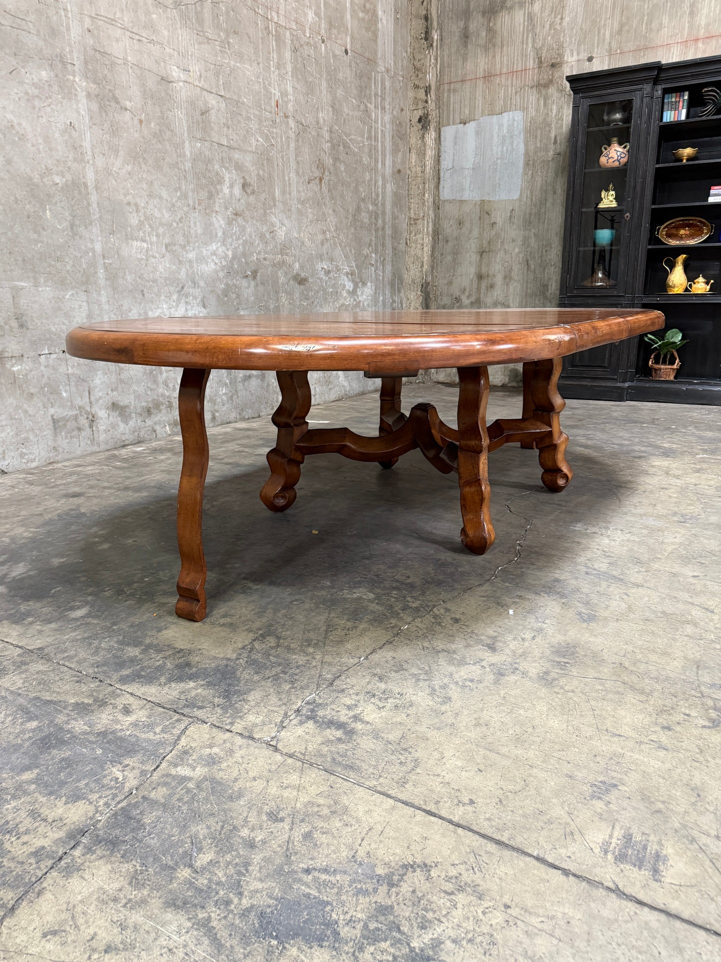 Custom Early Spanish Style Walnut Dining Table – Round to Oval with Leaves, Carved Stretcher Base, 107″L × 60″W × 30″H