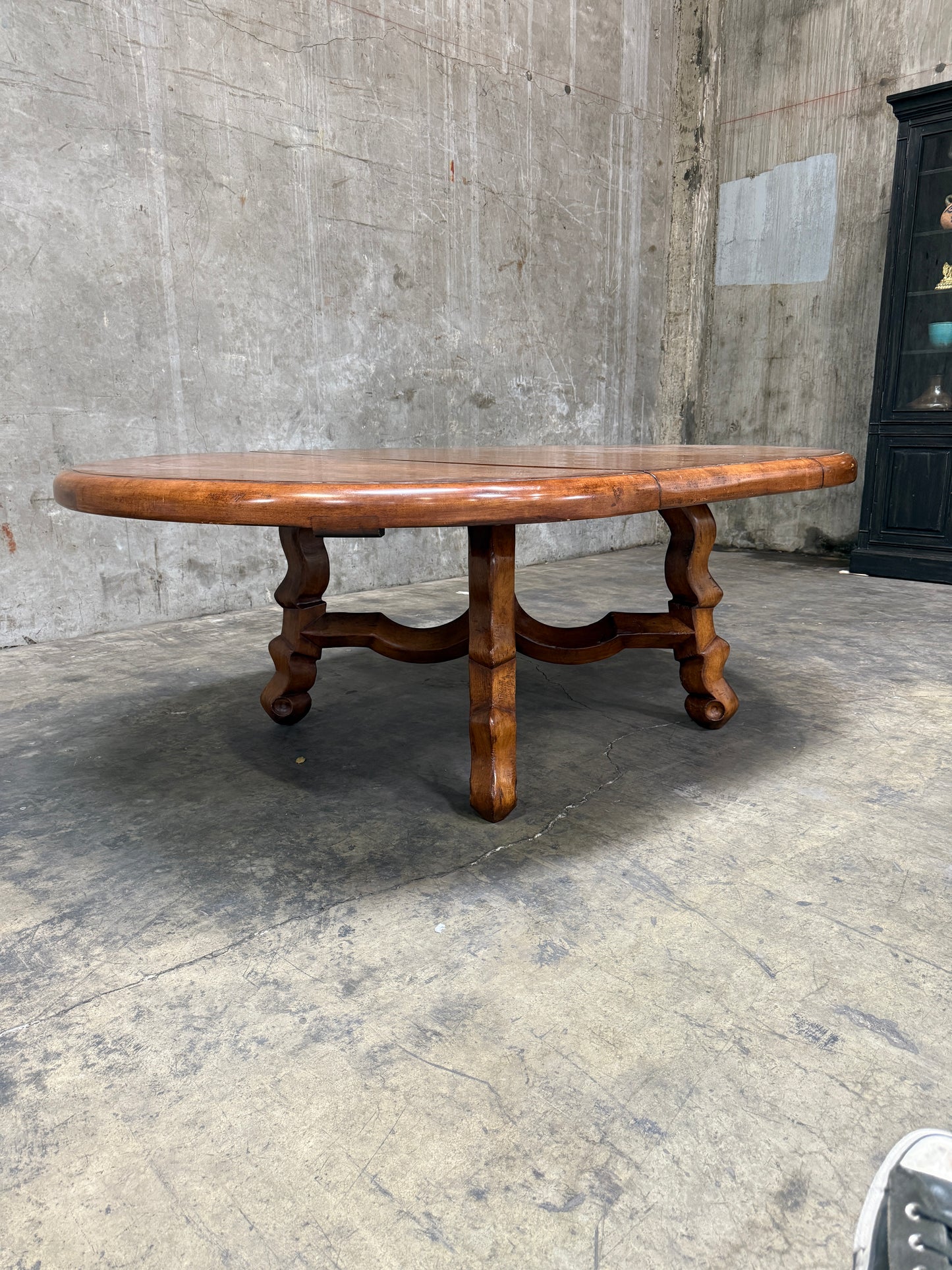 Custom Early Spanish Style Walnut Dining Table – Round to Oval with Leaves, Carved Stretcher Base, 107″L × 60″W × 30″H