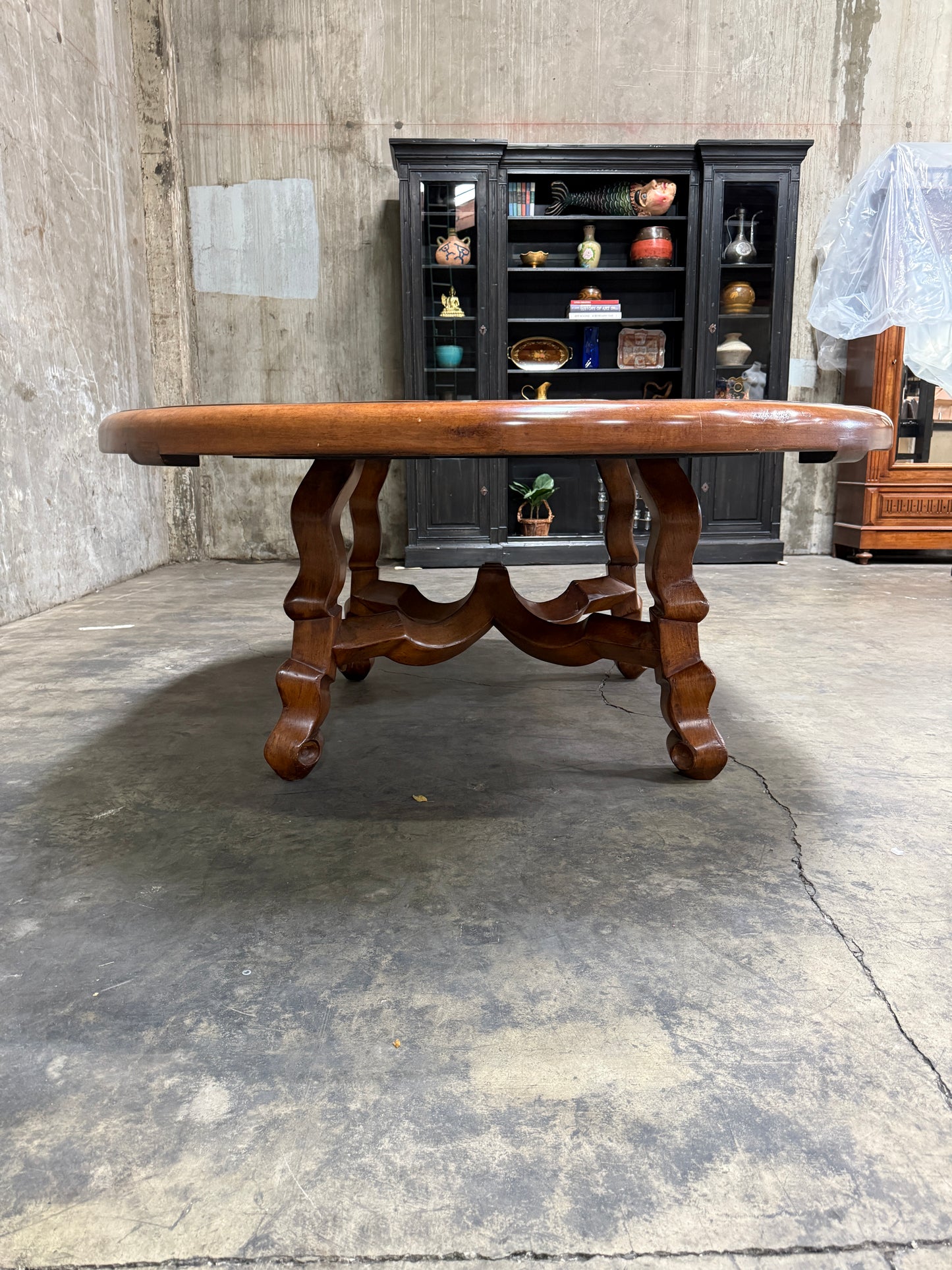 Custom Early Spanish Style Walnut Dining Table – Round to Oval with Leaves, Carved Stretcher Base, 107″L × 60″W × 30″H